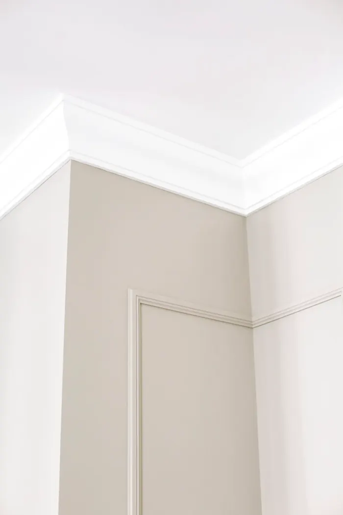 Ceiling cornice casting a shadow on a beige wall