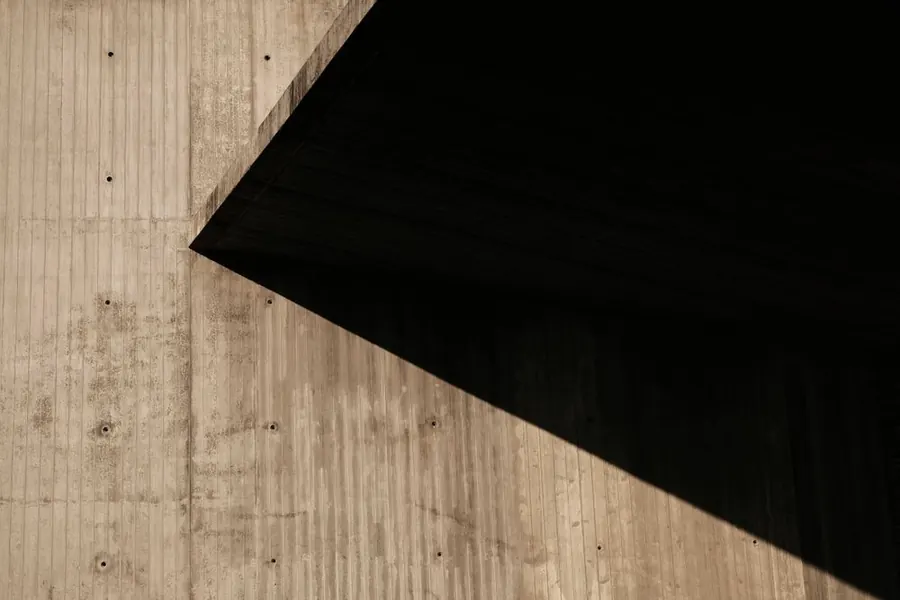 Board-formed concrete wall in strong shadow