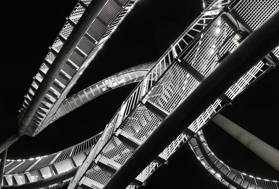 Blackened steel structure against a dark sky